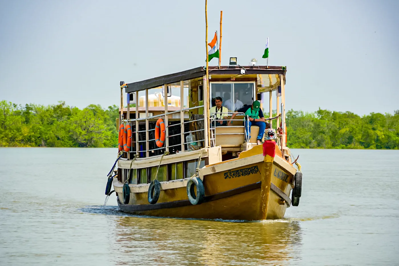 Max Adventures houseboat moving through the Sundarbans river channels during the day