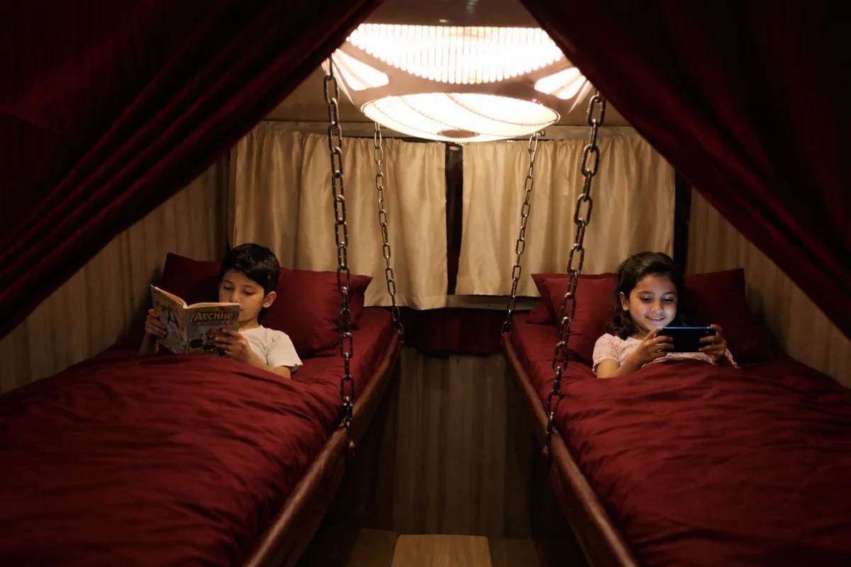 Children resting comfortably in bunk beds inside the Max Adventures houseboat